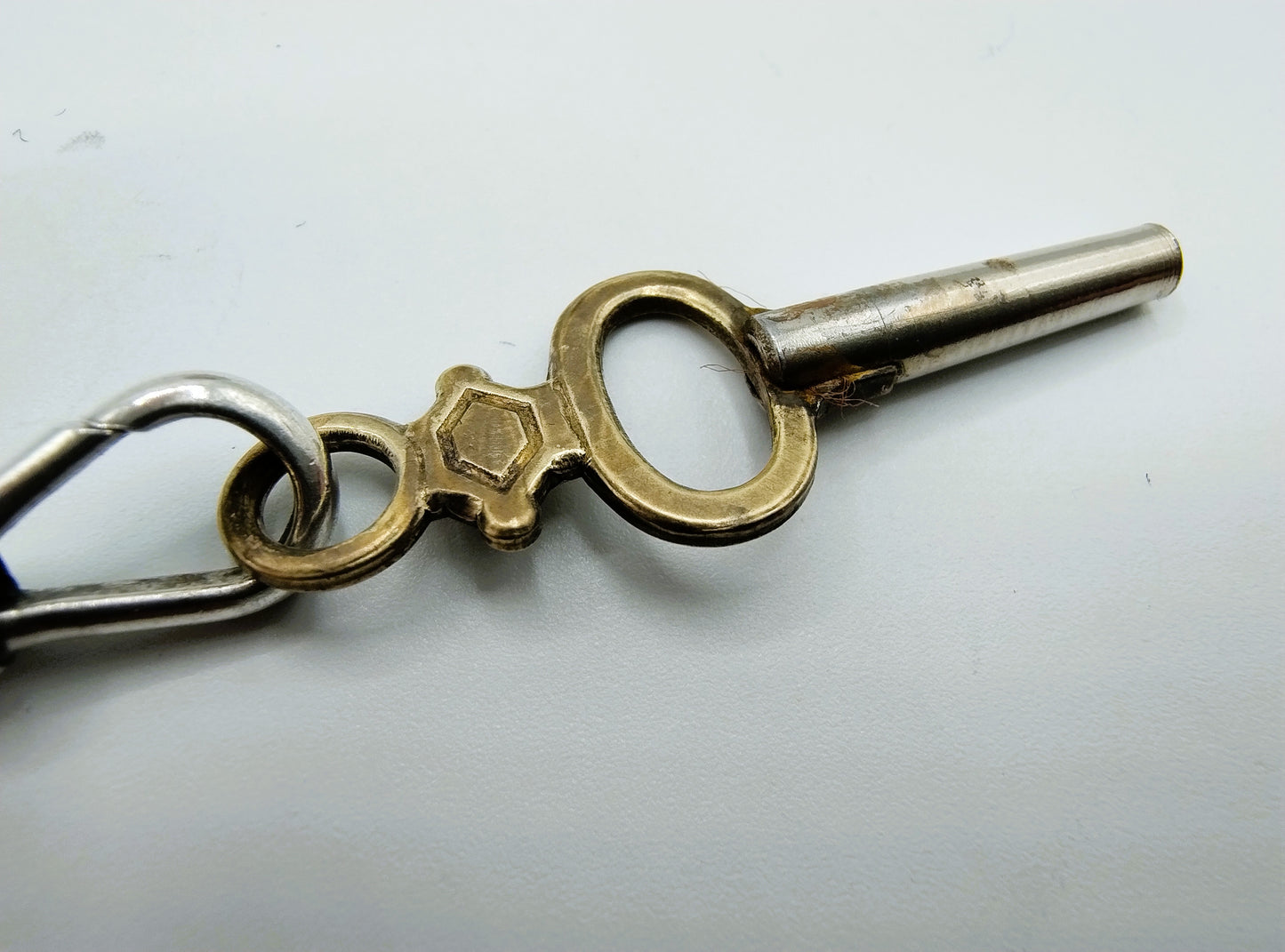 Silver pocket watch with watch chain and key