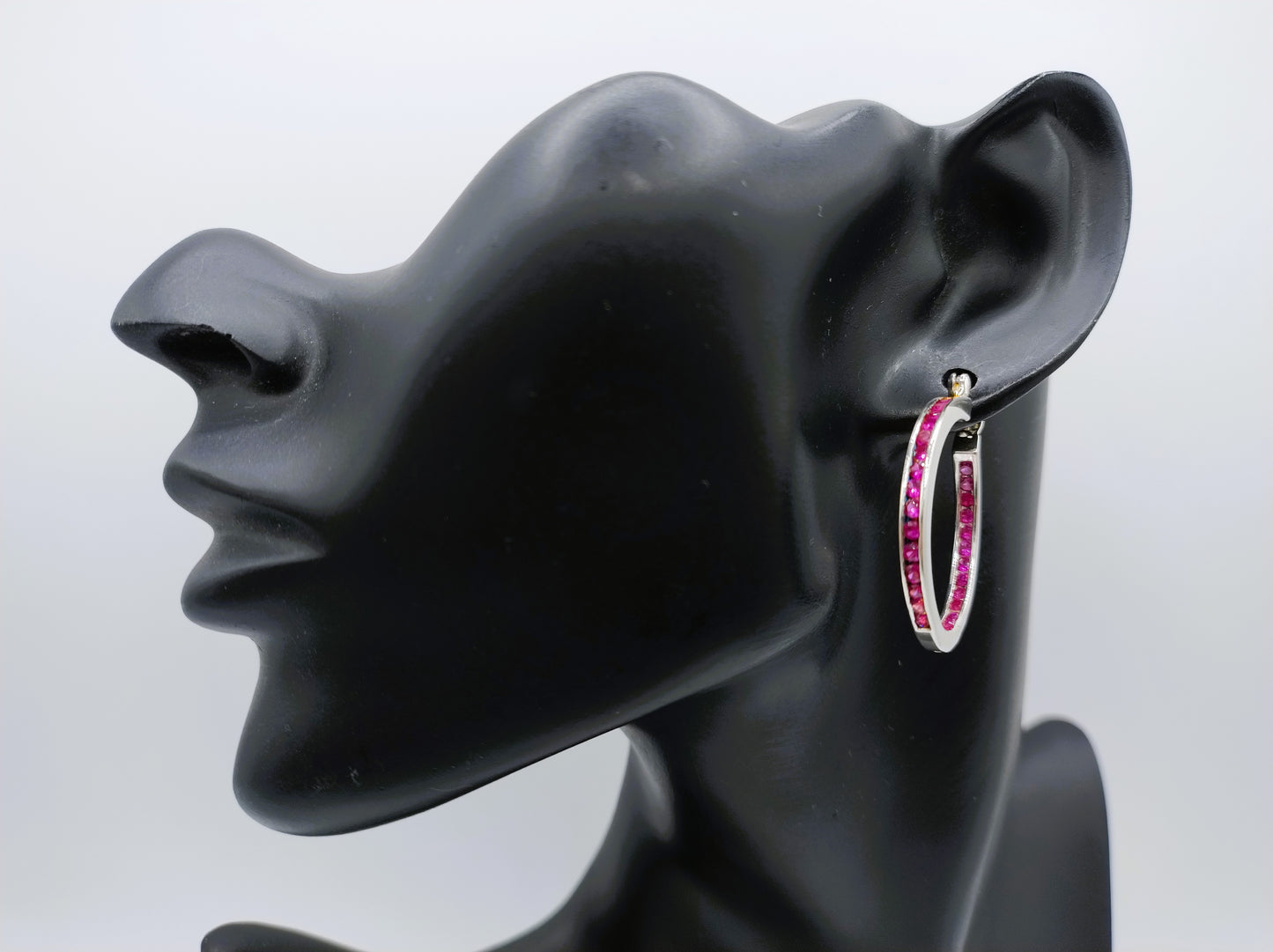Silver hoop earrings with pink stones