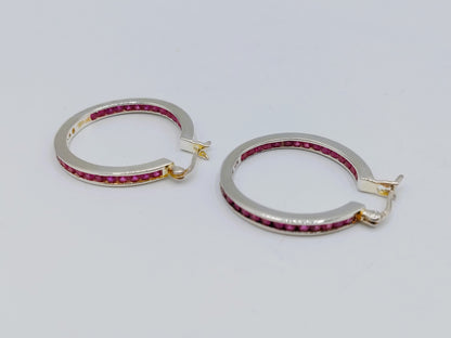 Silver hoop earrings with pink stones