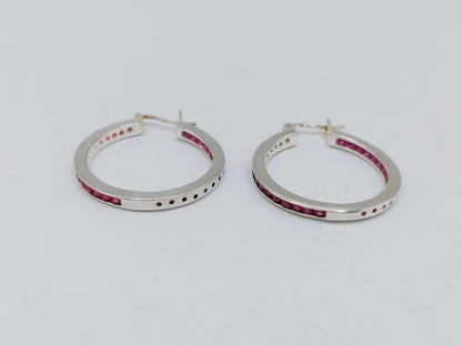 Silver hoop earrings with pink stones