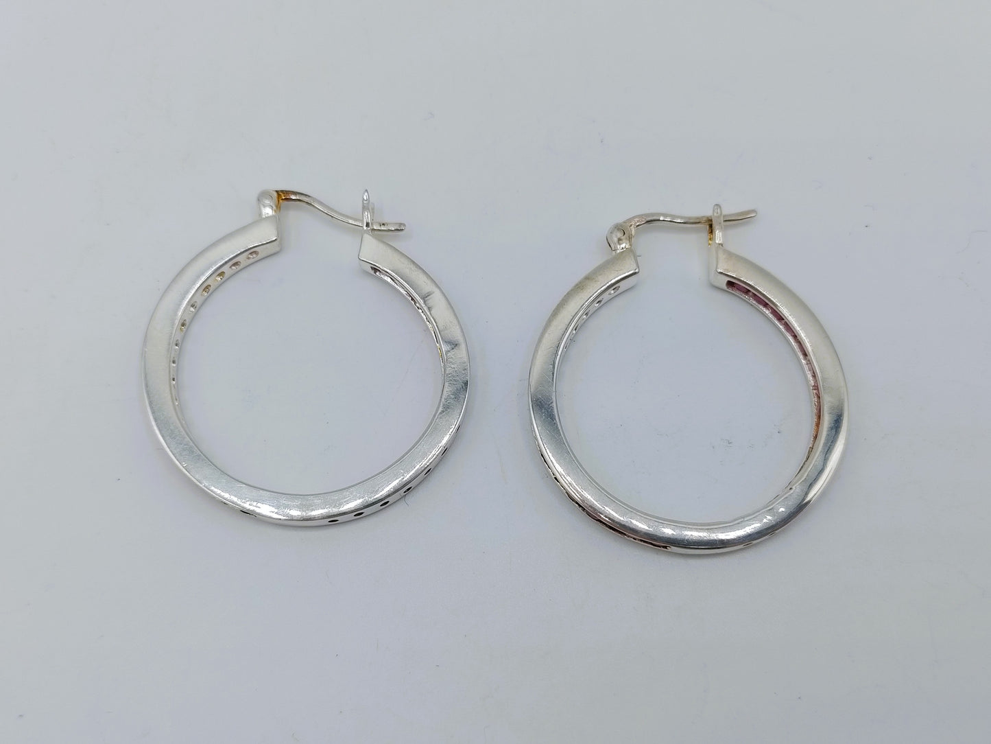 Silver hoop earrings with pink stones