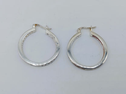 Silver hoop earrings with pink stones