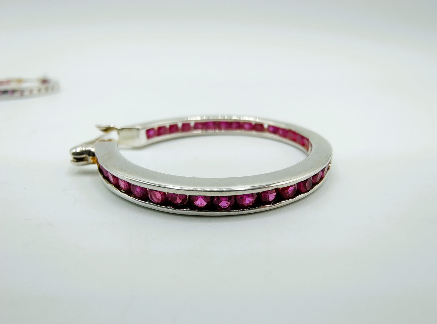 Silver hoop earrings with pink stones