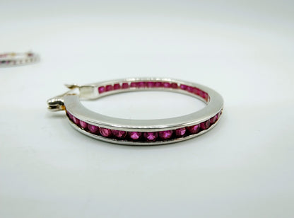 Silver hoop earrings with pink stones