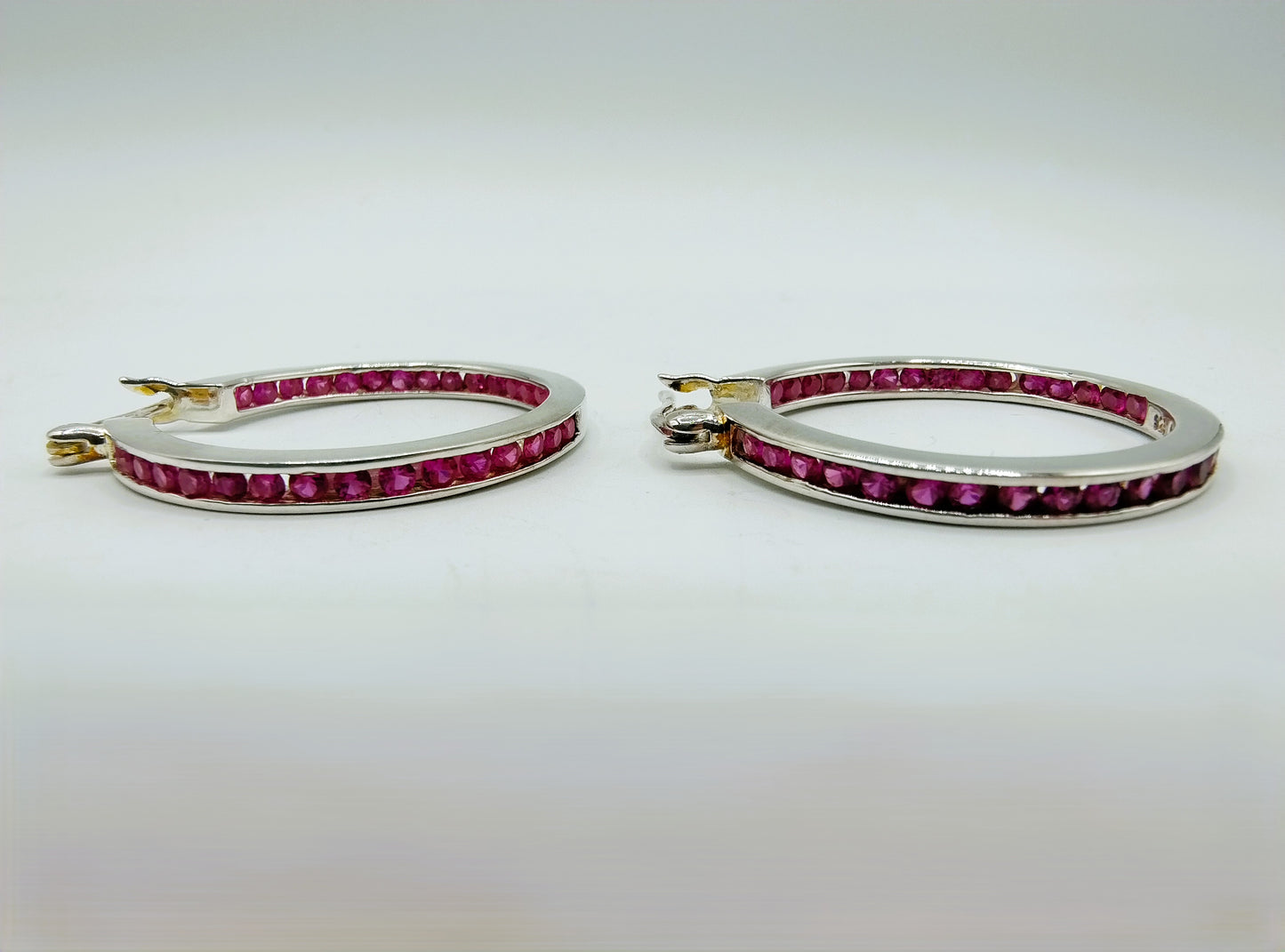 Silver hoop earrings with pink stones