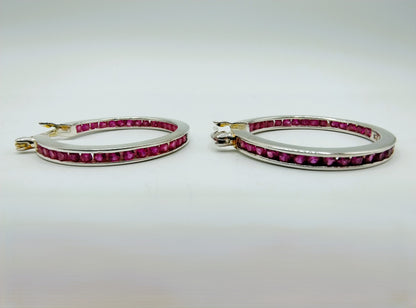 Silver hoop earrings with pink stones