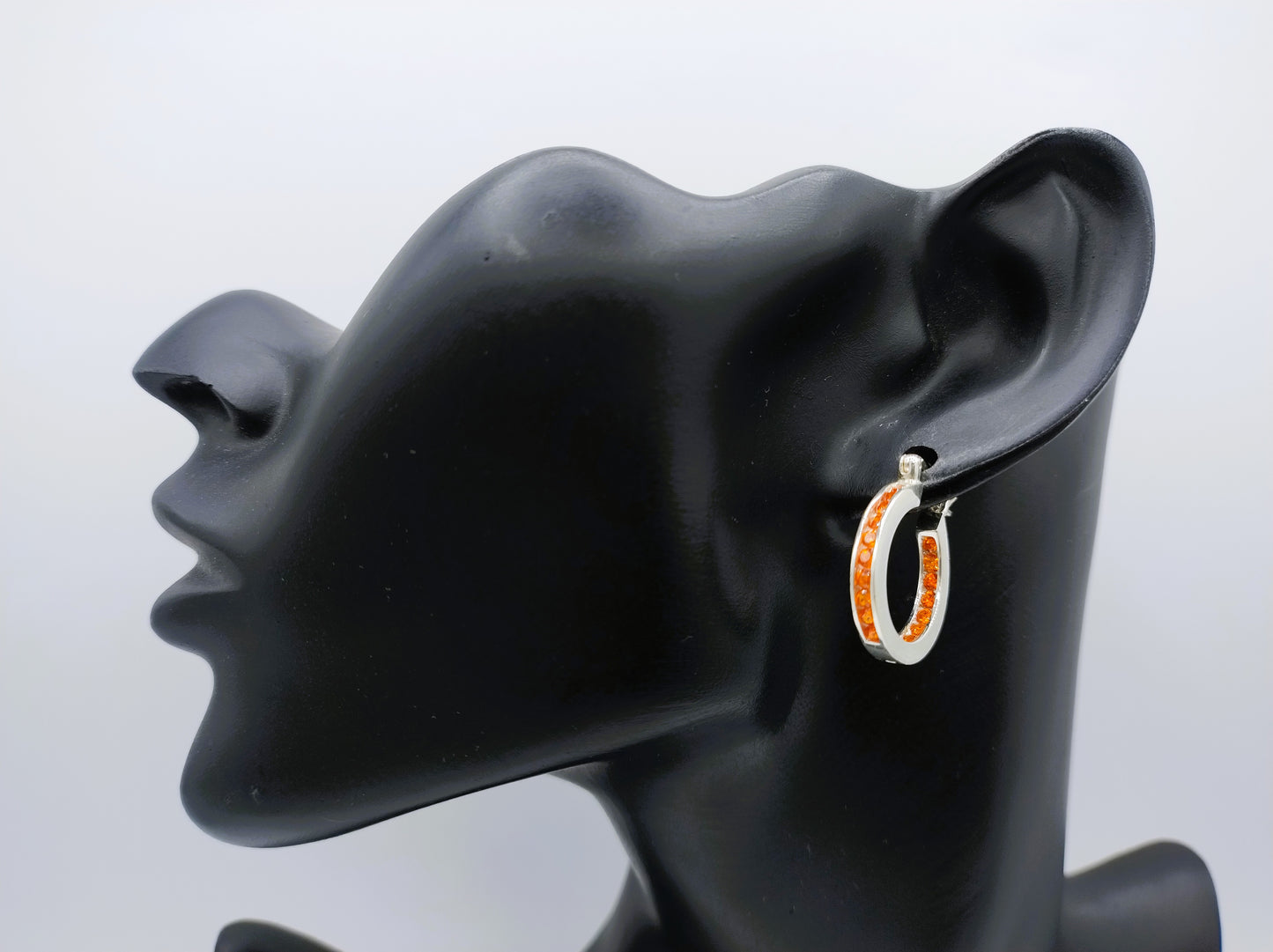Silver hoop earrings with orange stones
