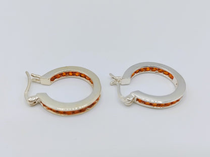 Silver hoop earrings with orange stones
