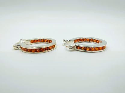 Silver hoop earrings with orange stones