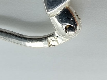 Silver hoop earrings with orange stones