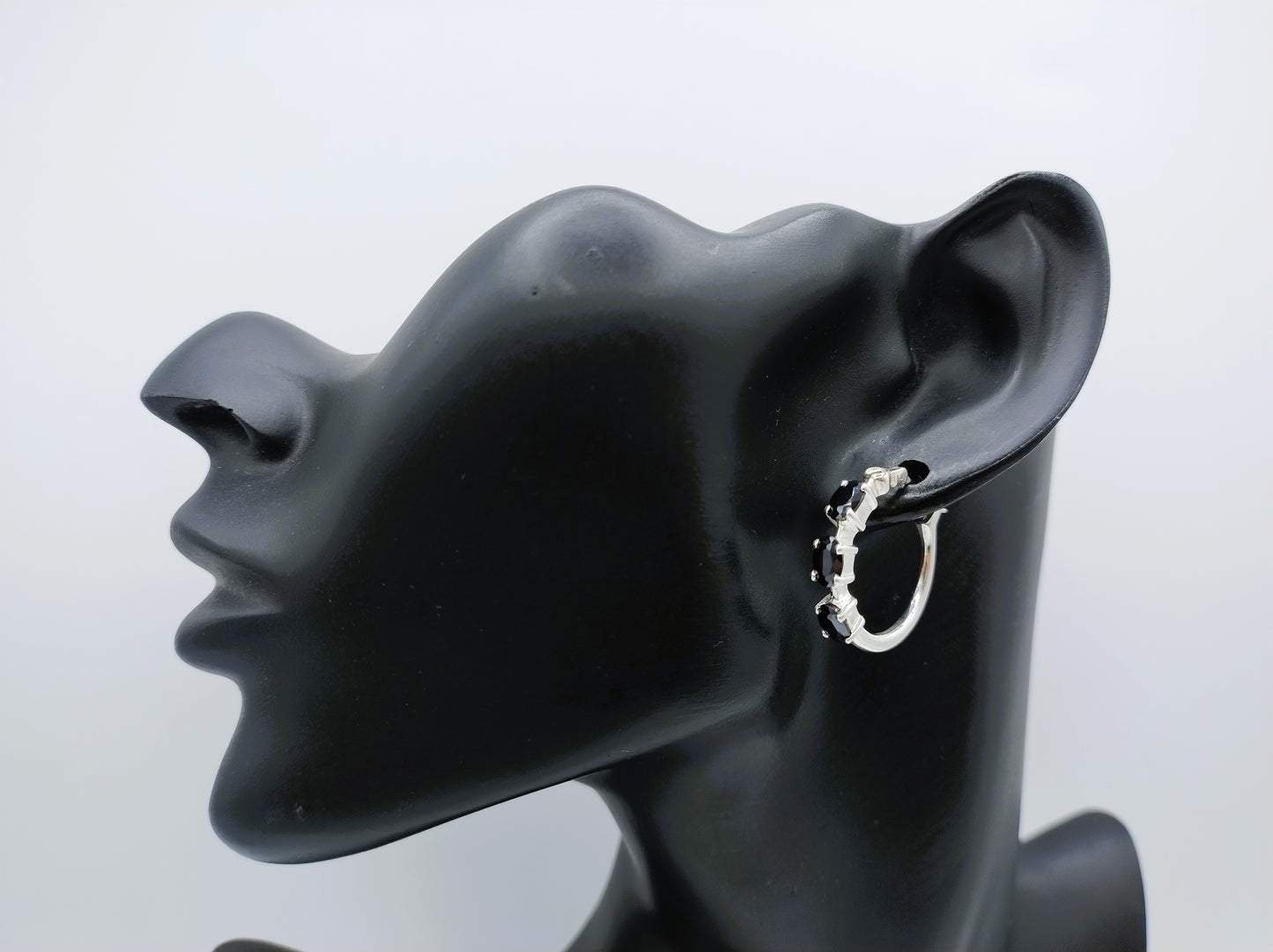 Silver hoop earrings with black stones
