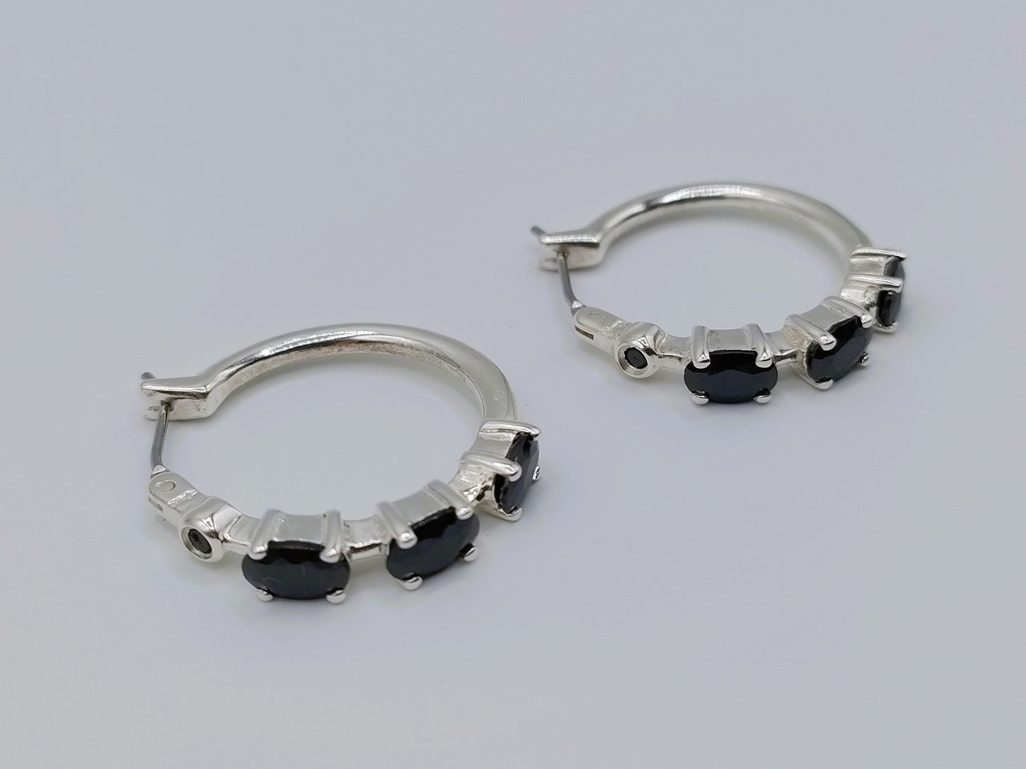 Silver hoop earrings with black stones