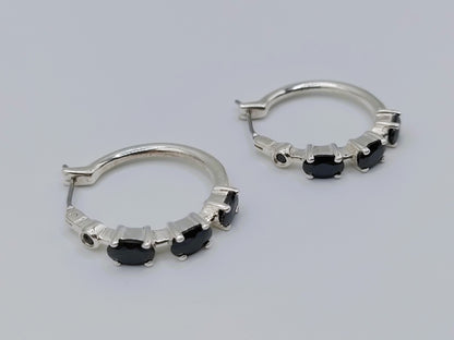 Silver hoop earrings with black stones