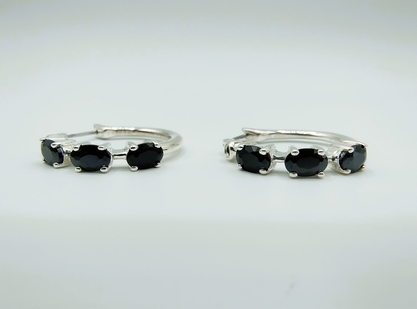 Silver hoop earrings with black stones
