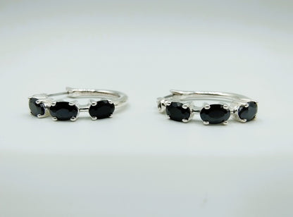 Silver hoop earrings with black stones