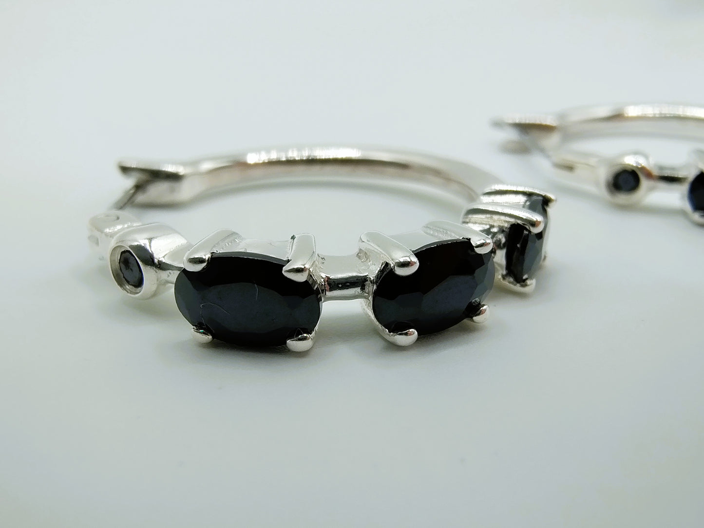 Silver hoop earrings with black stones
