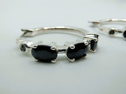 Silver hoop earrings with black stones