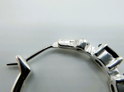 Silver hoop earrings with black stones