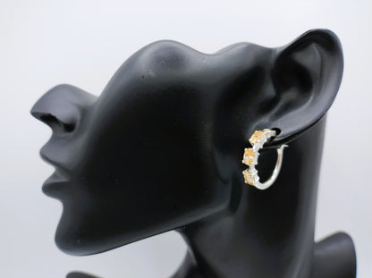 Silver hoop earrings with yellow stones
