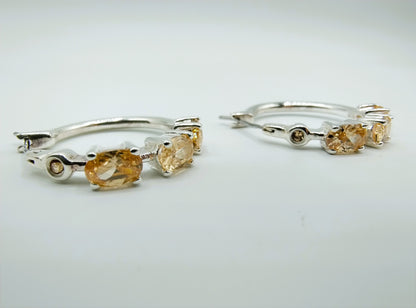 Silver hoop earrings with yellow stones