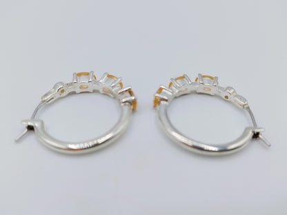 Silver hoop earrings with yellow stones