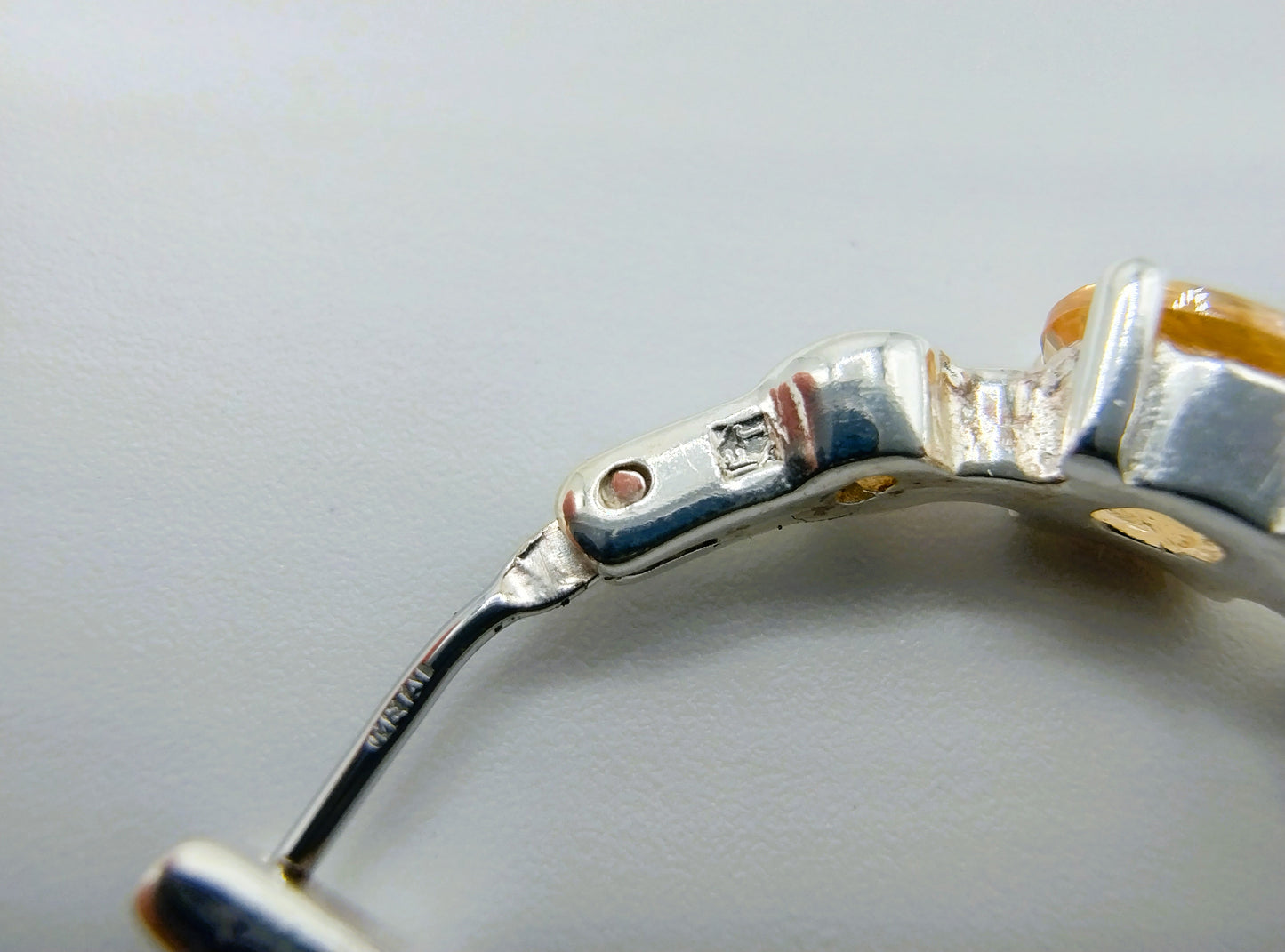 Silver hoop earrings with yellow stones
