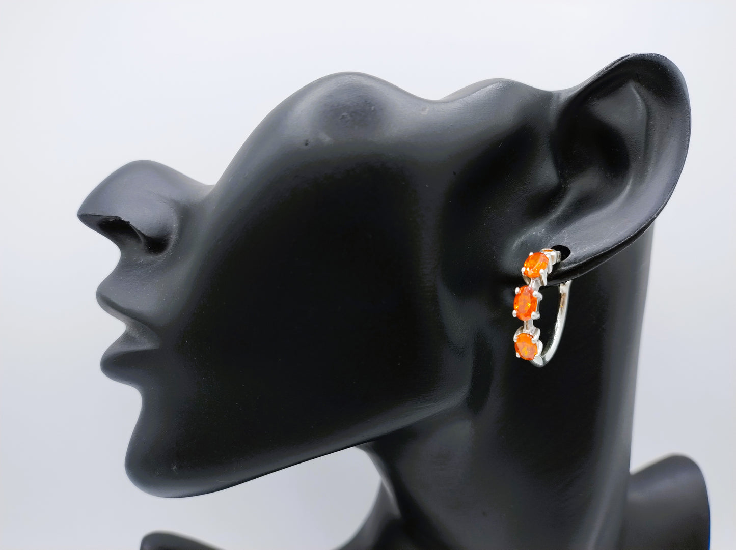 Silver hoop earrings with orange stones