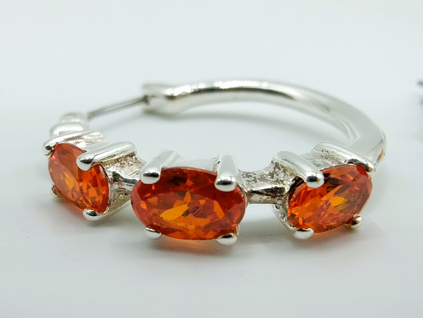 Silver hoop earrings with orange stones