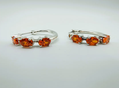 Silver hoop earrings with orange stones