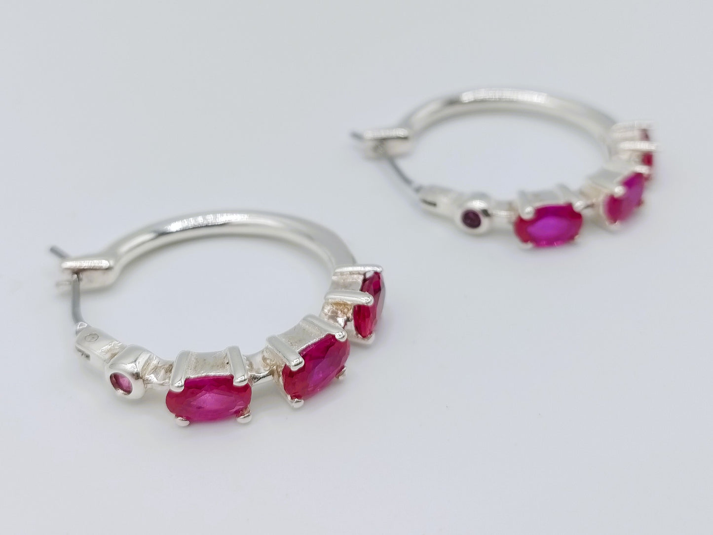 Silver hoop earrings with purple stones