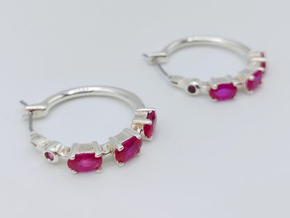 Silver hoop earrings with purple stones