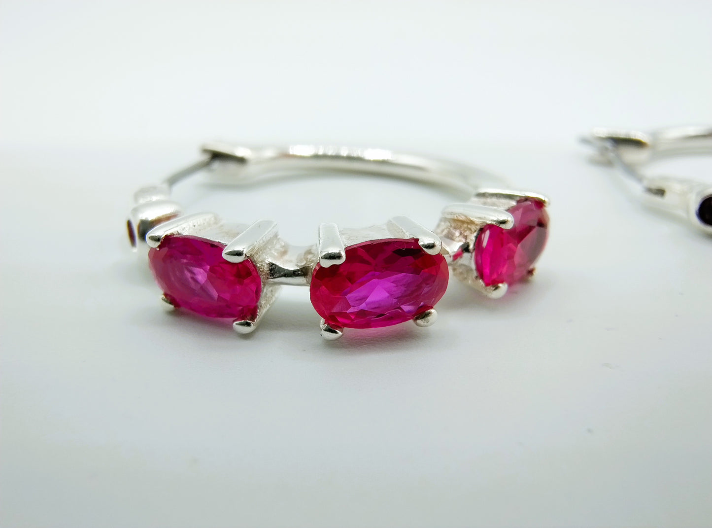 Silver hoop earrings with purple stones