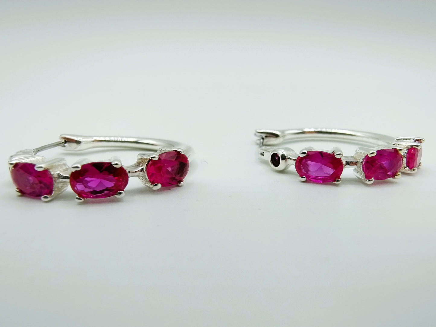 Silver hoop earrings with purple stones