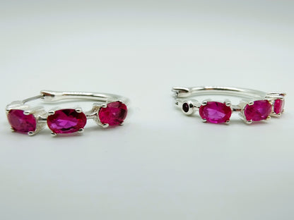 Silver hoop earrings with purple stones
