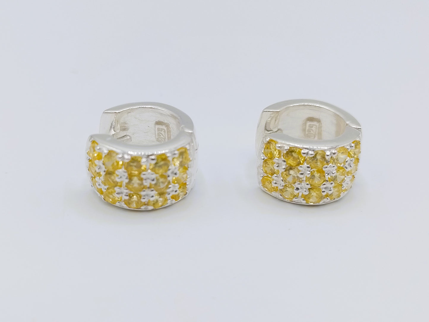Silver hoop earrings with yellow stones