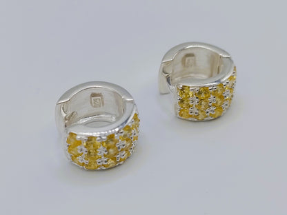 Silver hoop earrings with yellow stones
