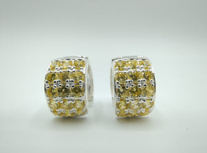 Silver hoop earrings with yellow stones