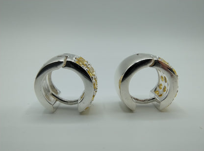 Silver hoop earrings with yellow stones