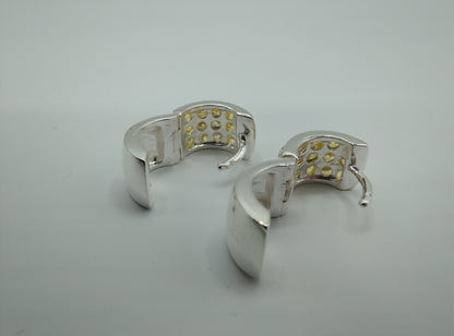 Silver hoop earrings with yellow stones