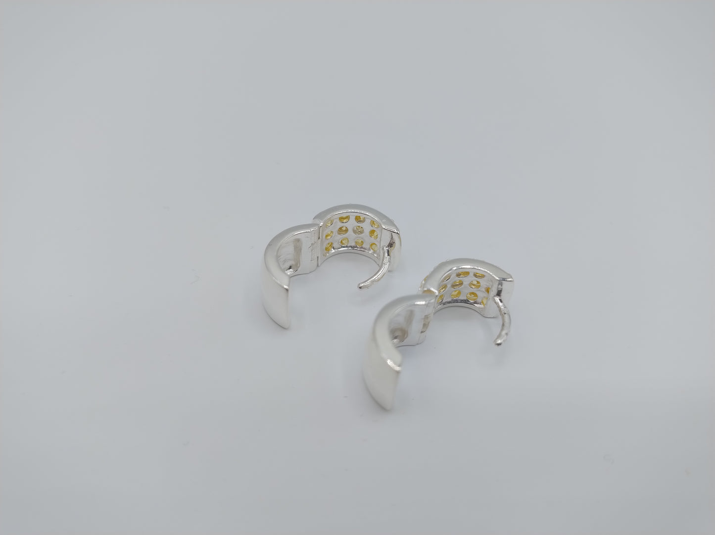 Silver hoop earrings with yellow stones