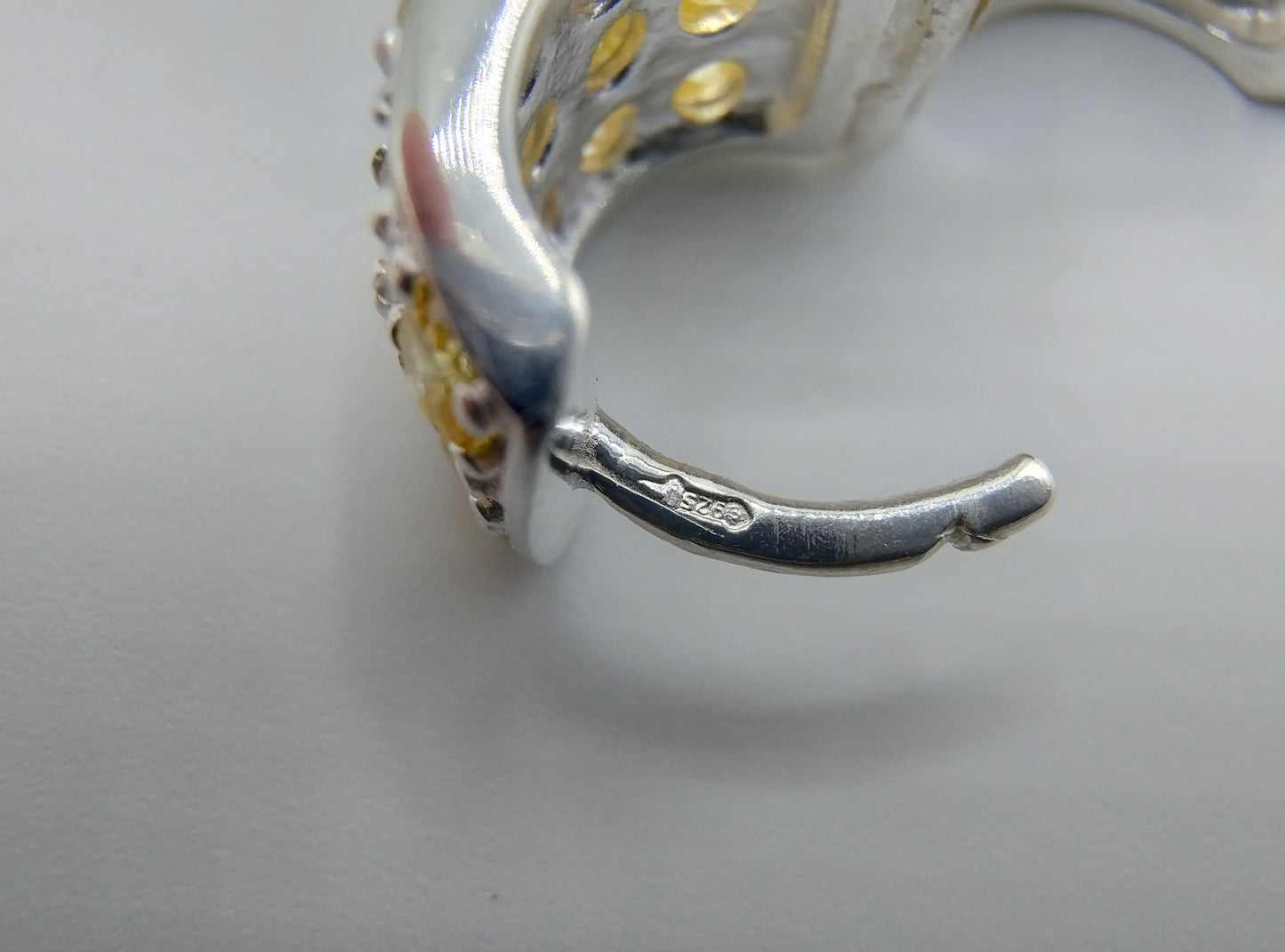 Silver hoop earrings with yellow stones