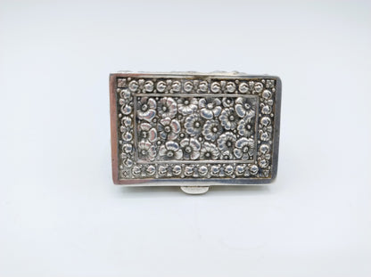 Silver pill box with a floral decoration