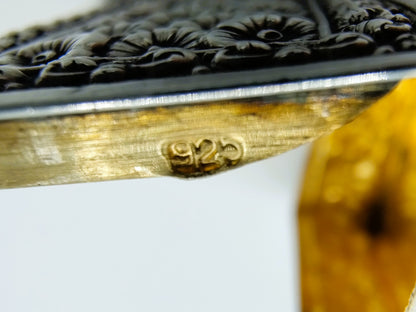 Silver pill box with a floral decoration