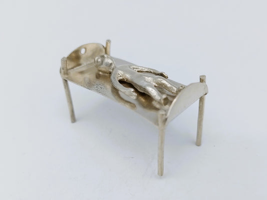 Silver miniature bed with figure, 18th century