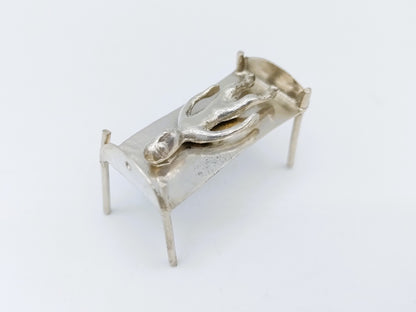 Silver miniature bed with figure, 18th century