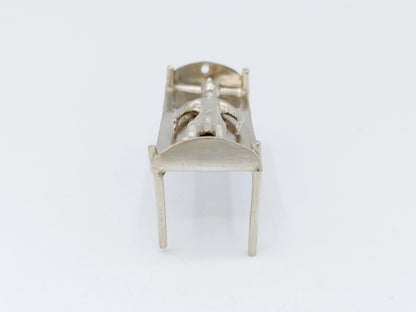 Silver miniature bed with figure, 18th century