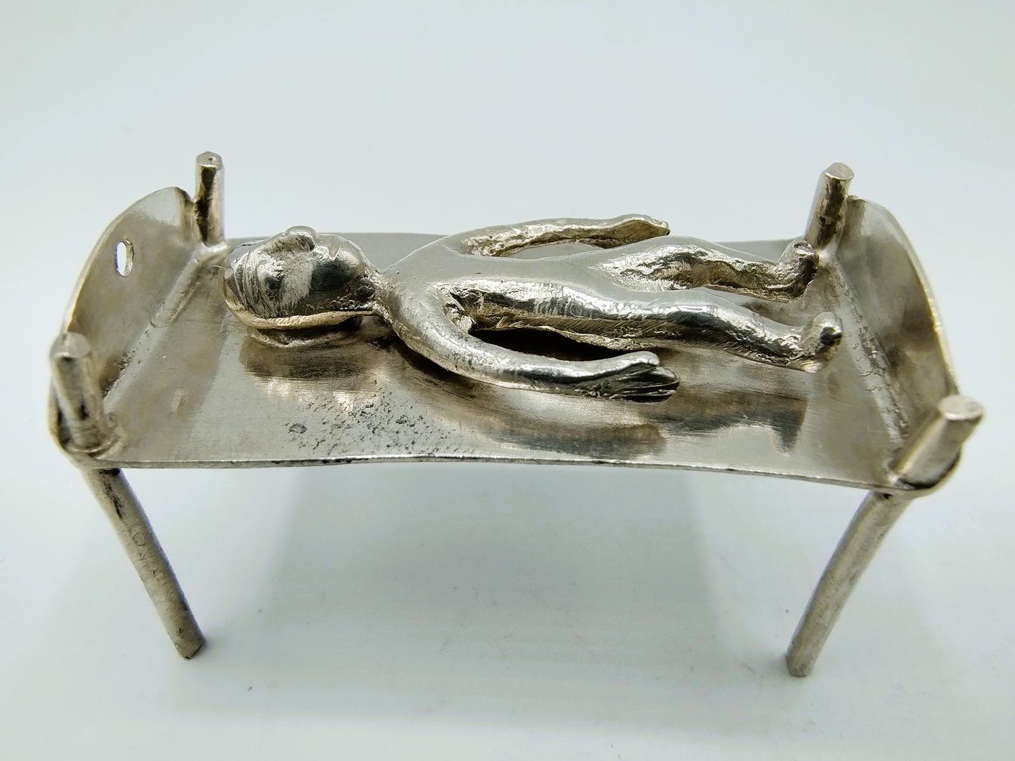 Silver miniature bed with figure, 18th century