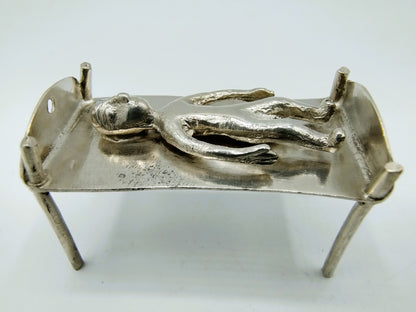 Silver miniature bed with figure, 18th century