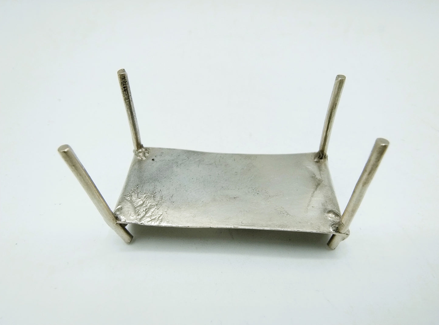 Silver miniature bed with figure, 18th century