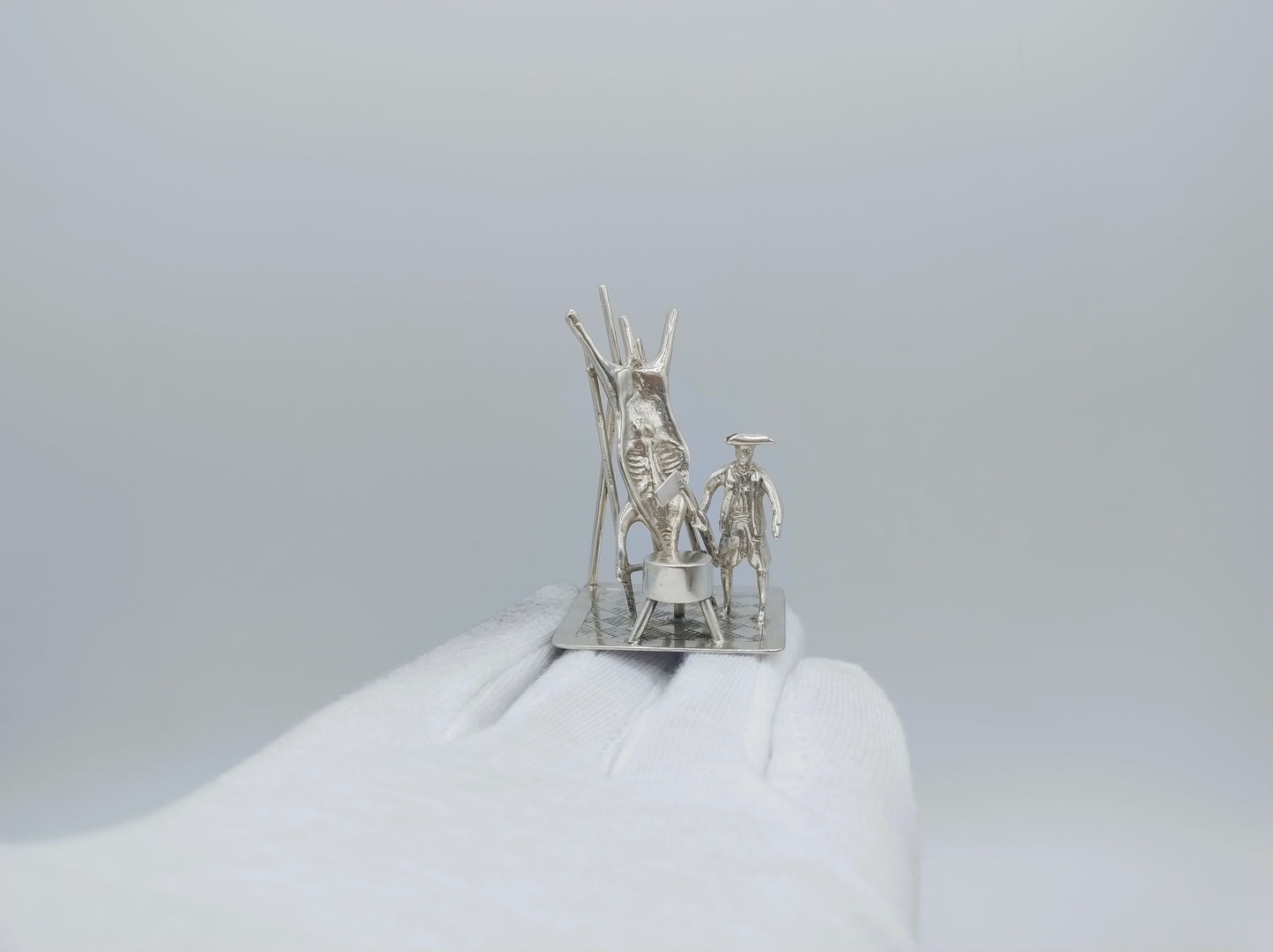 Silver miniature, butcher with pig on ladder, 18th century